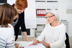 13226742-businesswomen-looking-at-the-document-together.jpg