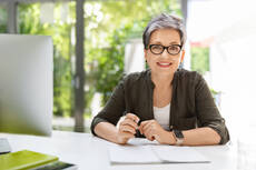 mp62734723-cheerful-mature-woman-business-consultant-working-at-office.jpg