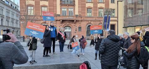 personer som står med plakat där det står stoppa angiverilagen